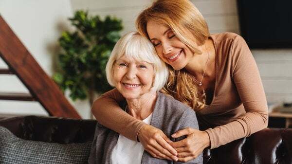 memory-care-young-woman-hugging-elderly-mother-2